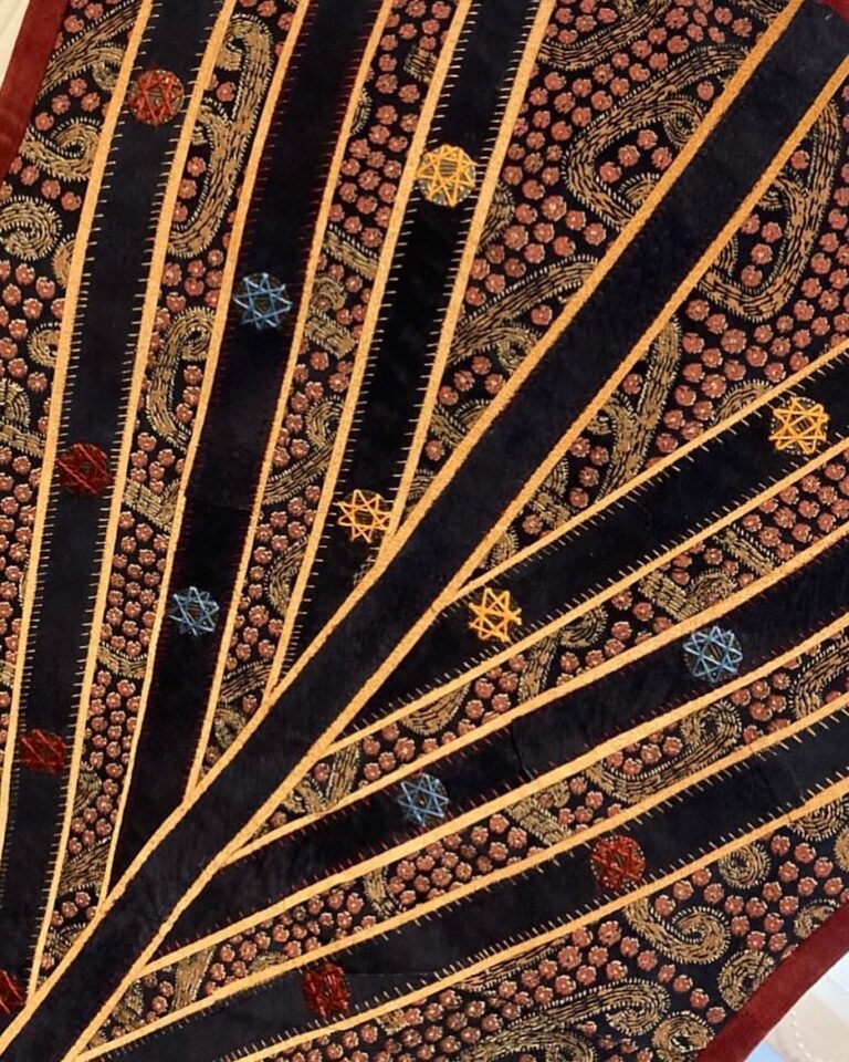 Radiating panels edged in gold thread, with couched stars, fanning out from a single point
